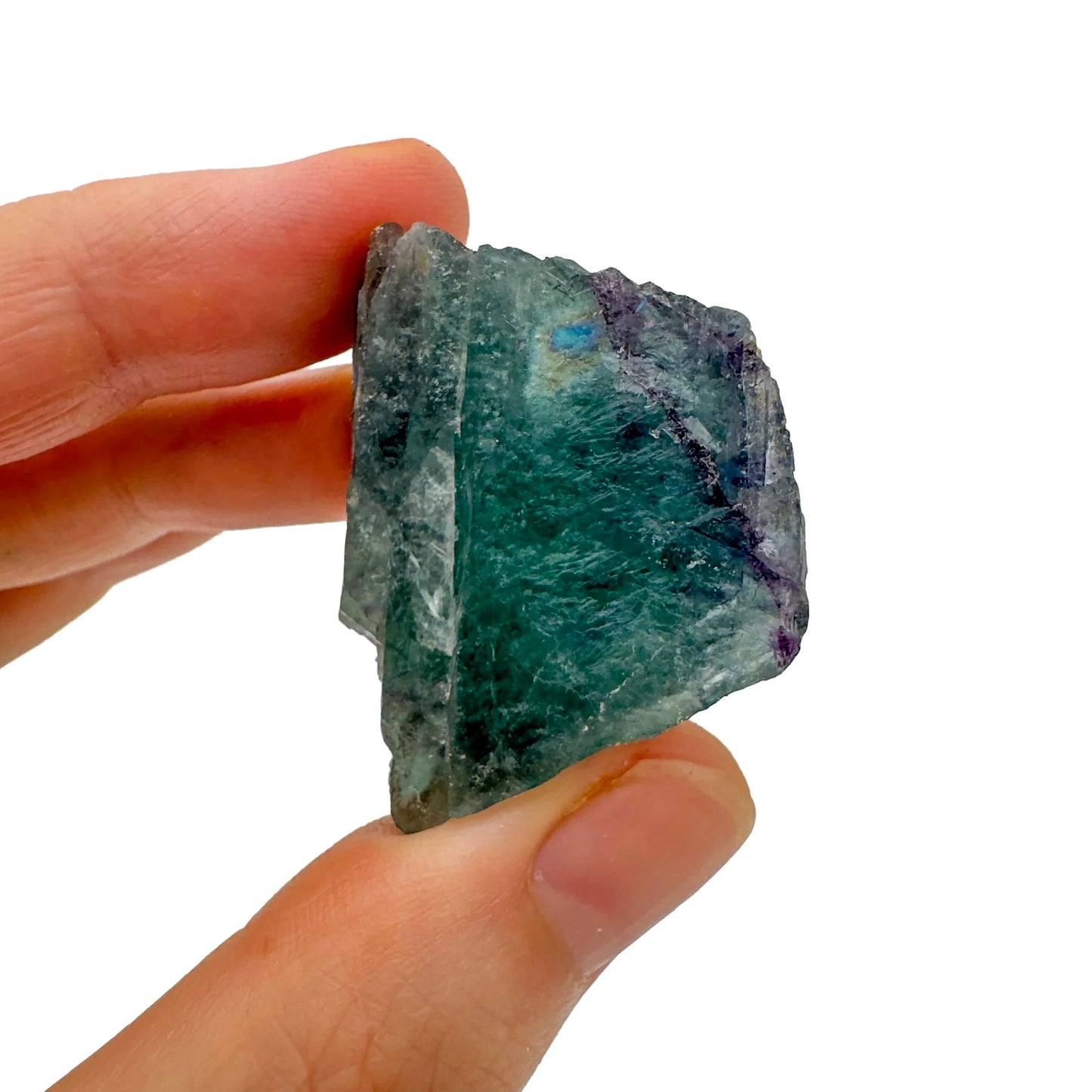 Lifestyle view of a Fluorite raw stone held against natural backdrop, sourced from Erongo, Namibia.