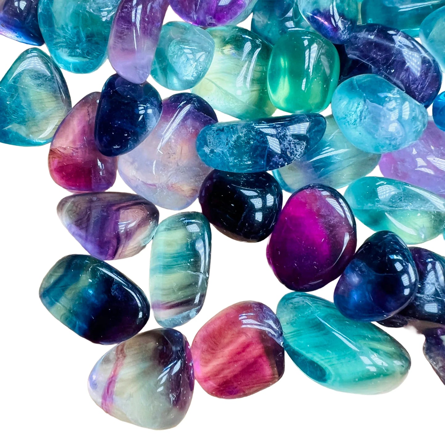 Looking down on Grade AAA Fluorite tumbled stone, often worked with for Focus, showing translucent edges.