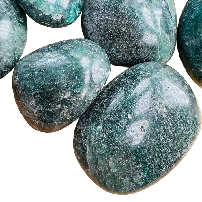 Looking down on Grade AA Fuchsite palm stone, showing natural sheen, from Madagascar.