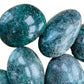 Rear view of green Fuchsite palm stone, showing characteristic finish.