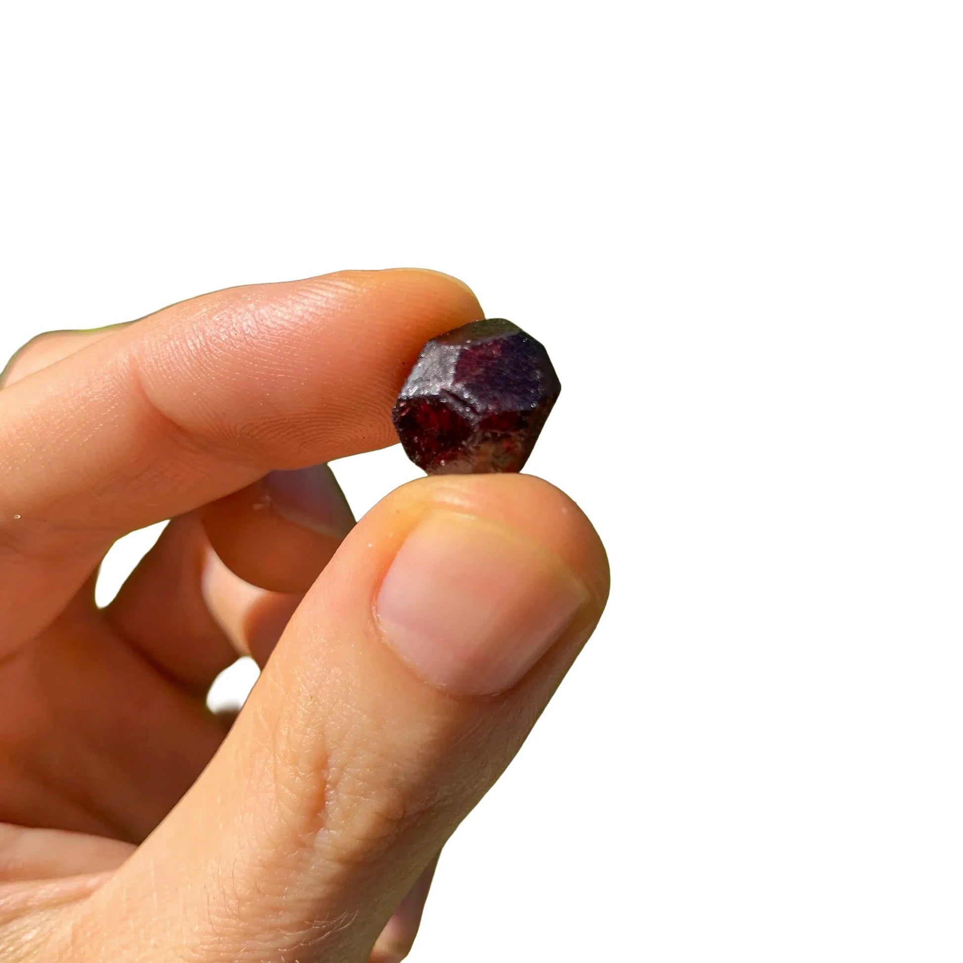 Hand-scale shot of a Garnet raw stone often kept for Energy and Confidence.