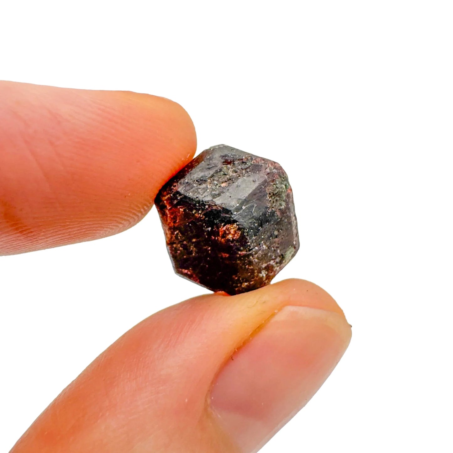 Holding a Fuchsite raw crystal, with natural details visible.