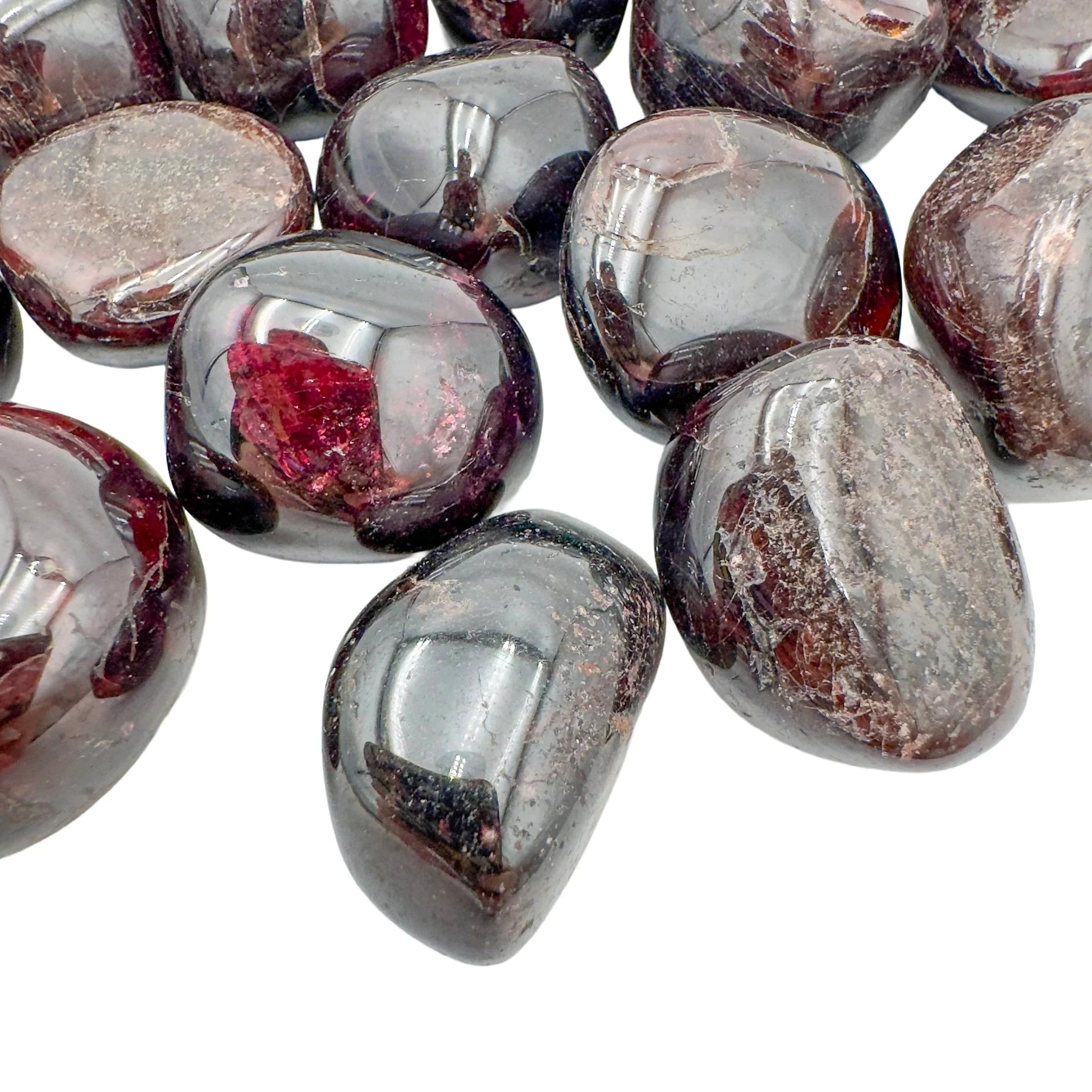 Sideways view of Garnet tumbled stone, showing soft luster, Malawi-sourced.