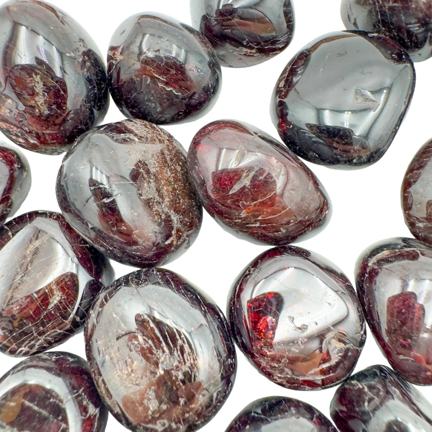 Hand-scale shot of a single Garnet tumbled stone hand-selected from Nsipe, Malawi.