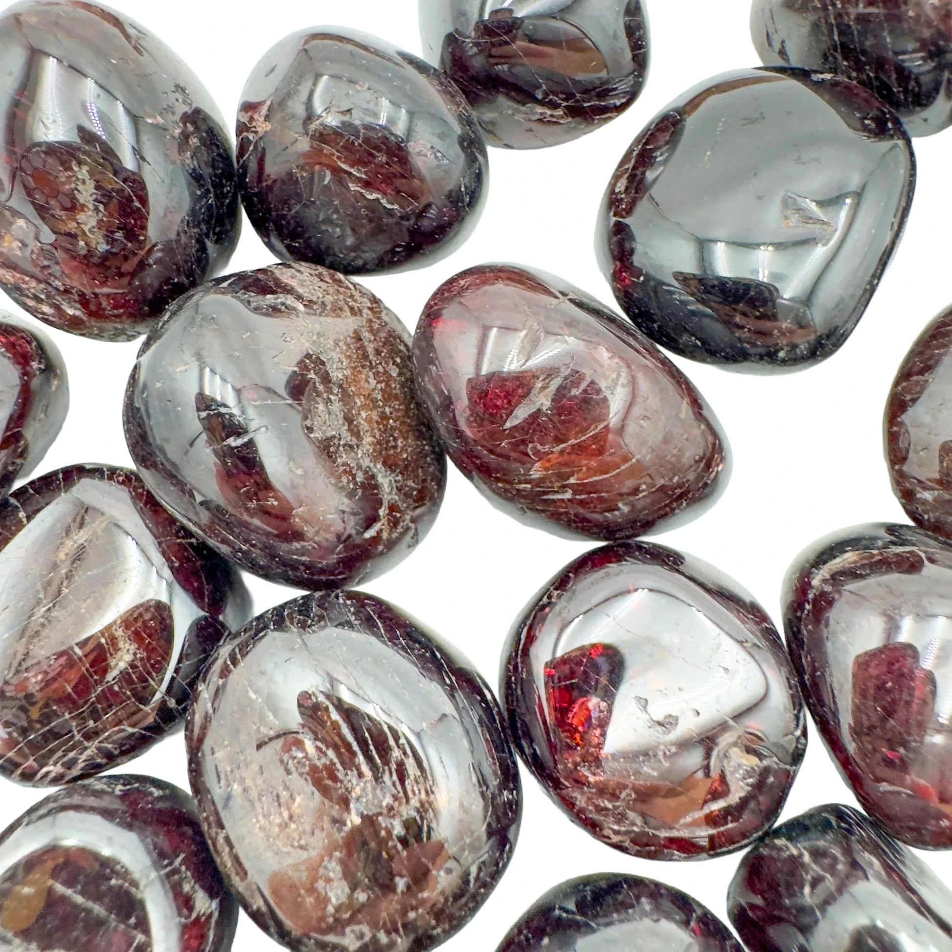Hand-scale shot of a single Garnet tumbled stone hand-selected from Nsipe, Malawi.