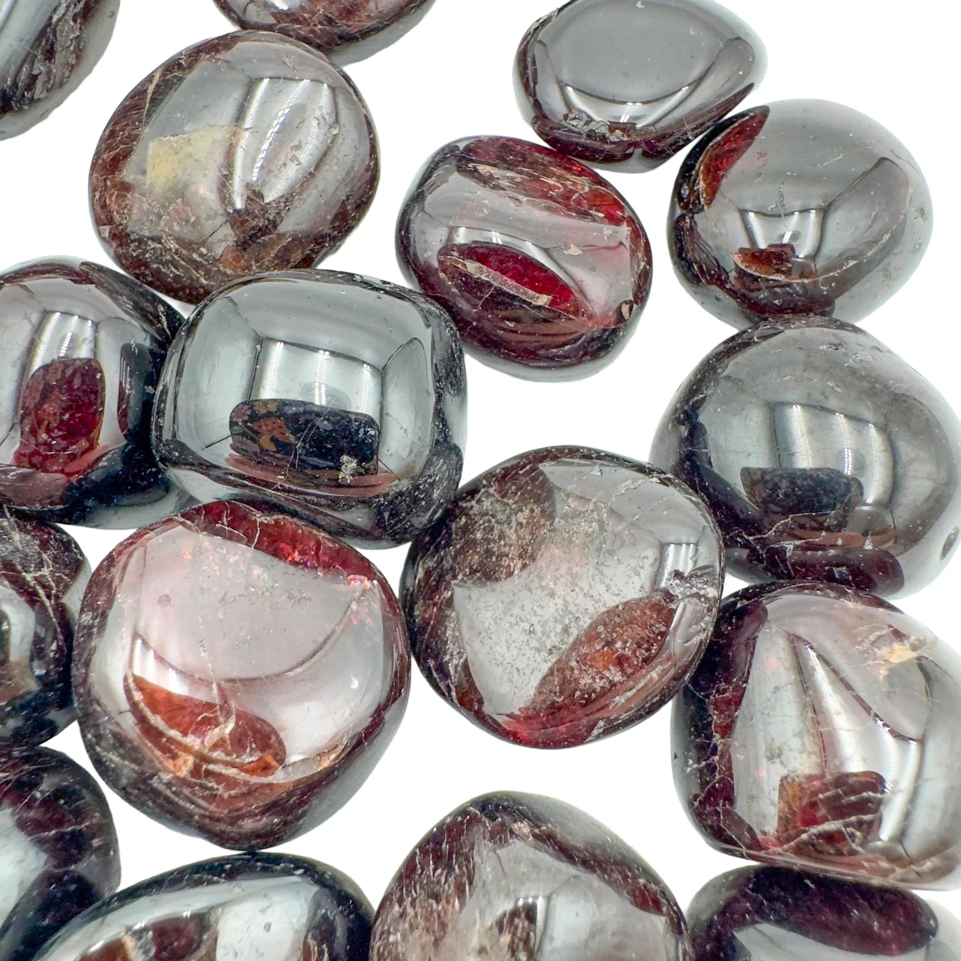 Quiet study of Garnet tumbled stone, from Nsipe, Malawi, captured against a quiet backdrop.