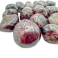 Near view of Garnet tumbled stone, sourced from Minas Gerais, Brazil, showing characteristic color.