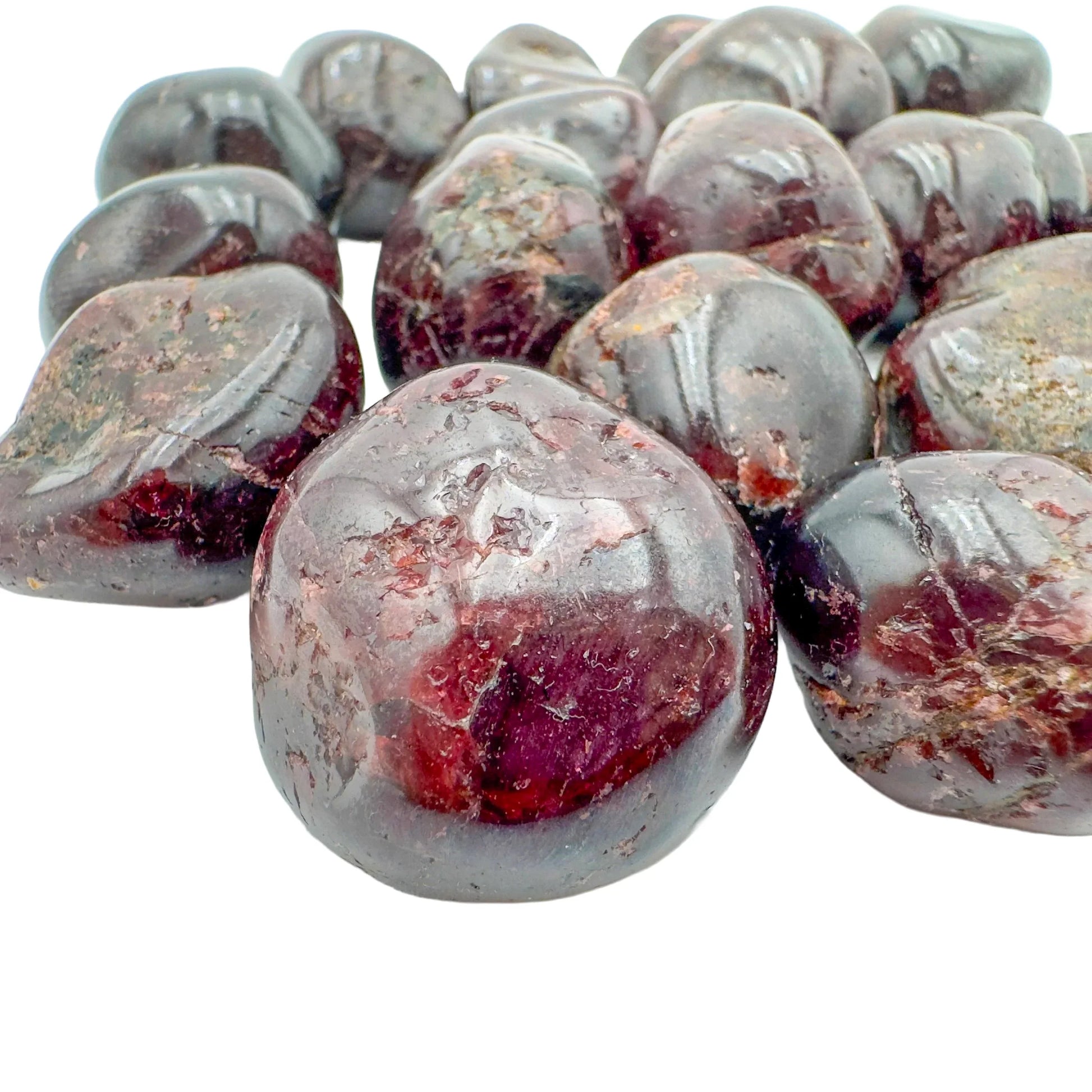 Near view of Garnet tumbled stone, sourced from Minas Gerais, Brazil, showing characteristic color.