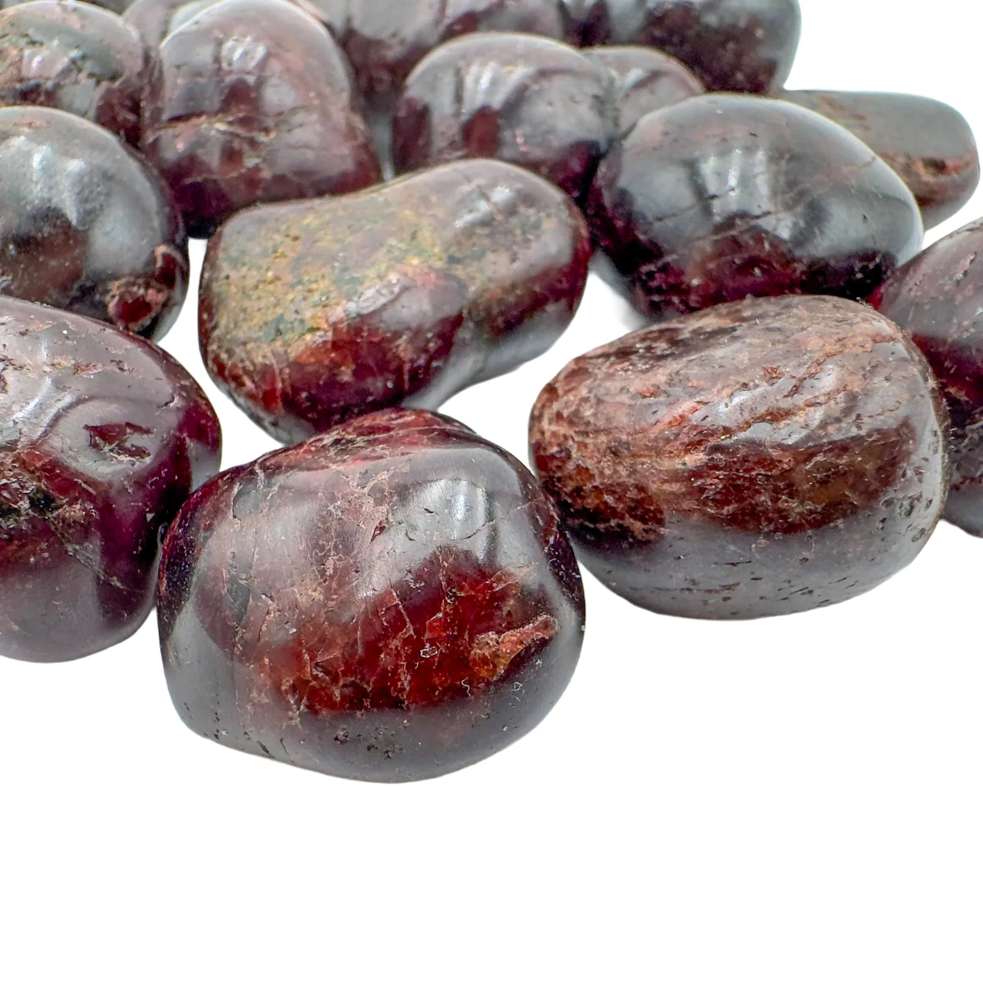 Side profile of Garnet tumbled stone, kept near for Energy and Confidence, showing natural texture.