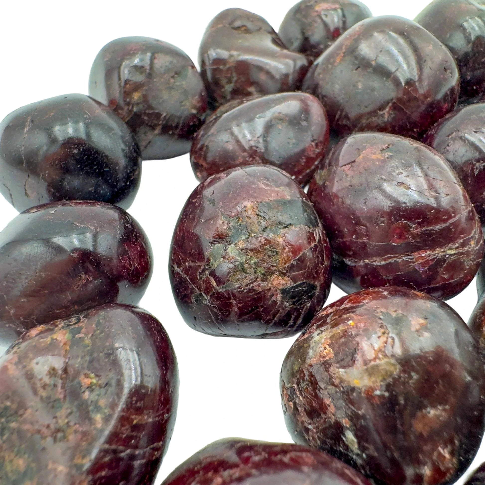 Looking down on Garnet tumbled stone, kept close for Energy, showing natural texture.