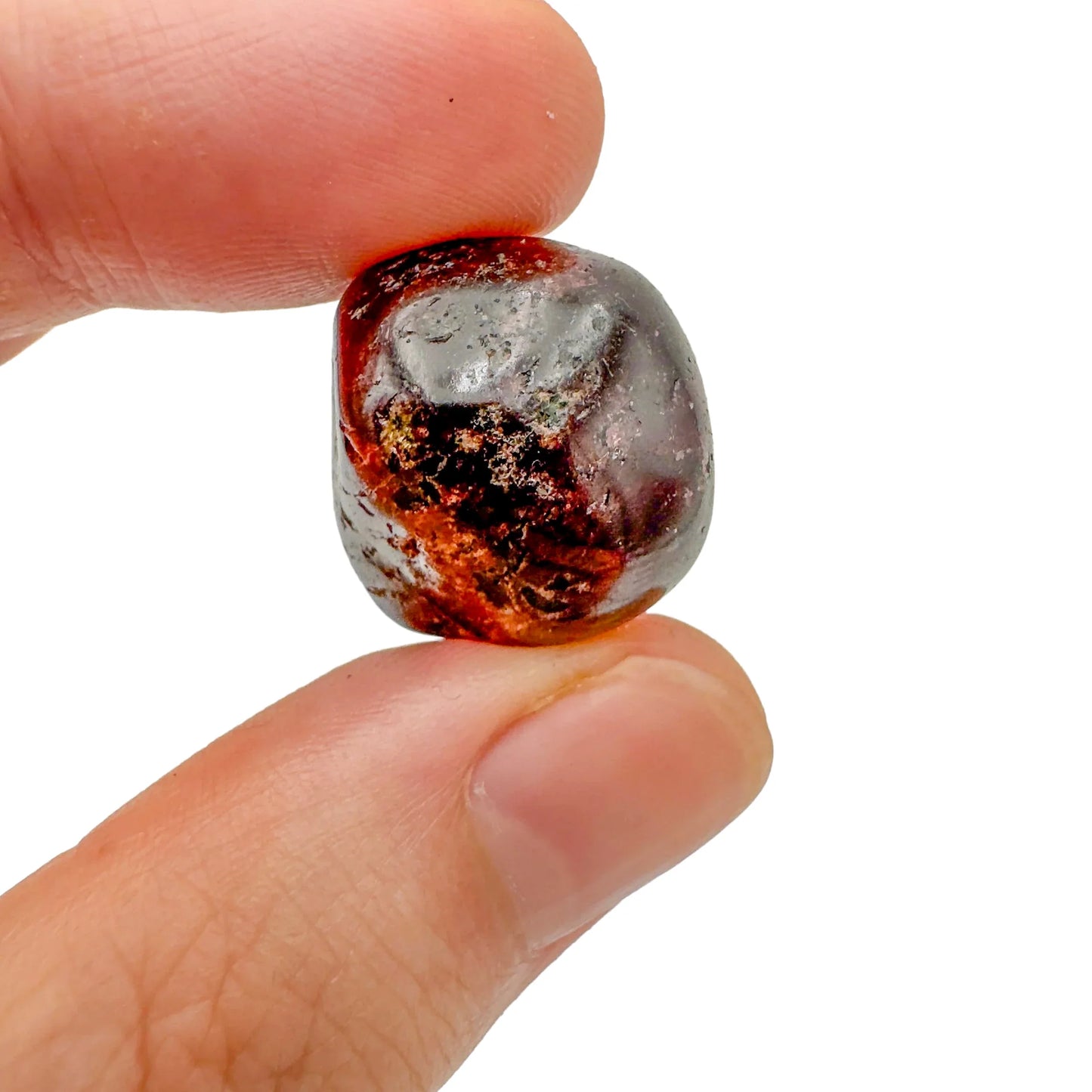 Held in hand, a single Garnet tumbled stone hand-selected from Minas Gerais, Brazil.