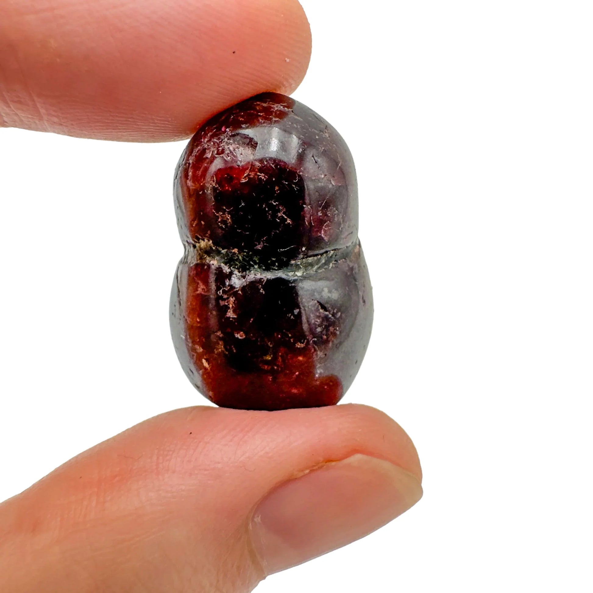 Three-quarter view of Garnet tumbled stone, shown in a calm studio setting.