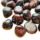 Near view of Grade AAA Garnet tumbled stone, linked to Energy.