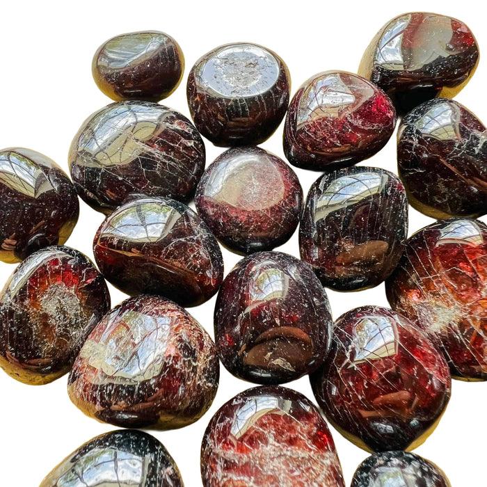 Sideways view of Garnet tumbled stone, showing natural sheen, linked to Energy and Confidence.