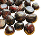 Overhead view of Garnet tumbled stone, showing translucent edges, from Nsipe, Malawi.