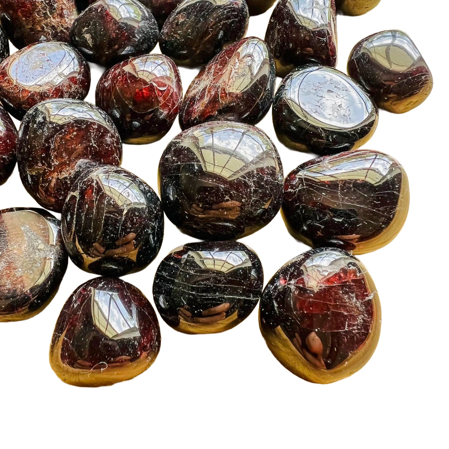 Overhead view of Garnet tumbled stone, showing translucent edges, from Nsipe, Malawi.