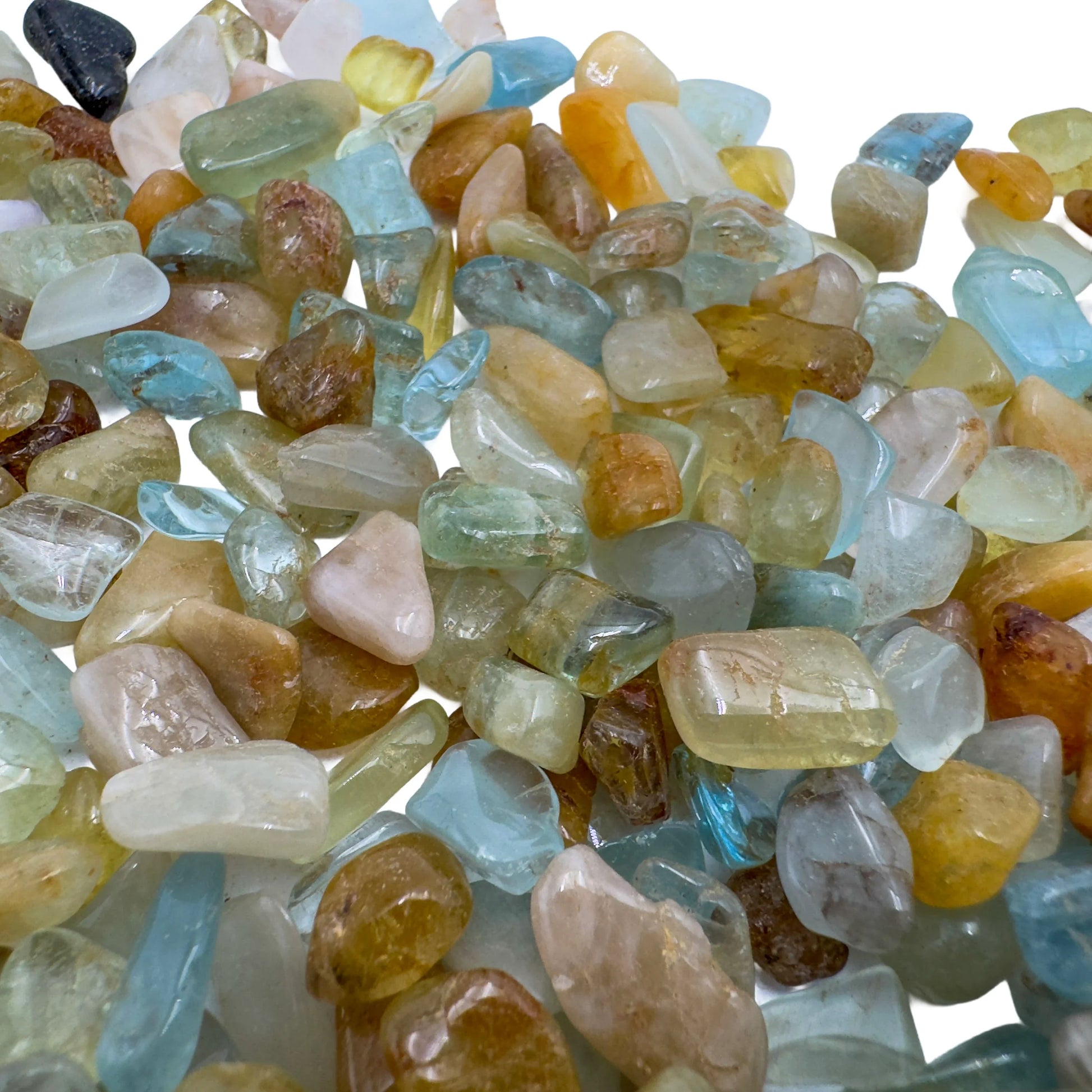 Holding an Aquamarine stone, from Huila, Angola, shown in a calm studio setting.