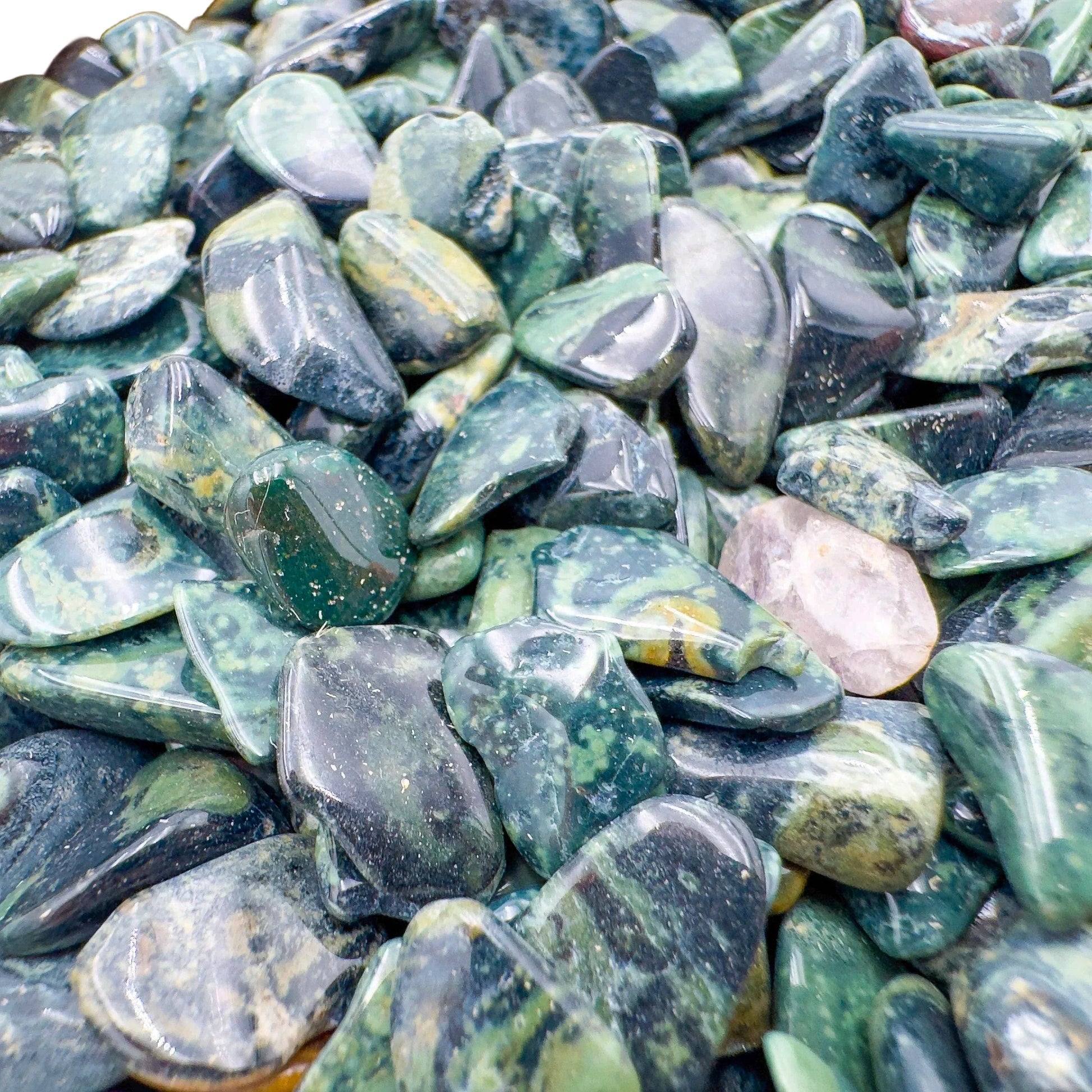 Detail of Kambaba Jasper polished chip, showing characteristic color, linked to Grounding and Stress Relief.