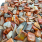 Petrified wood chips scattered on surface, ethically sourced Madagascar fossil wood