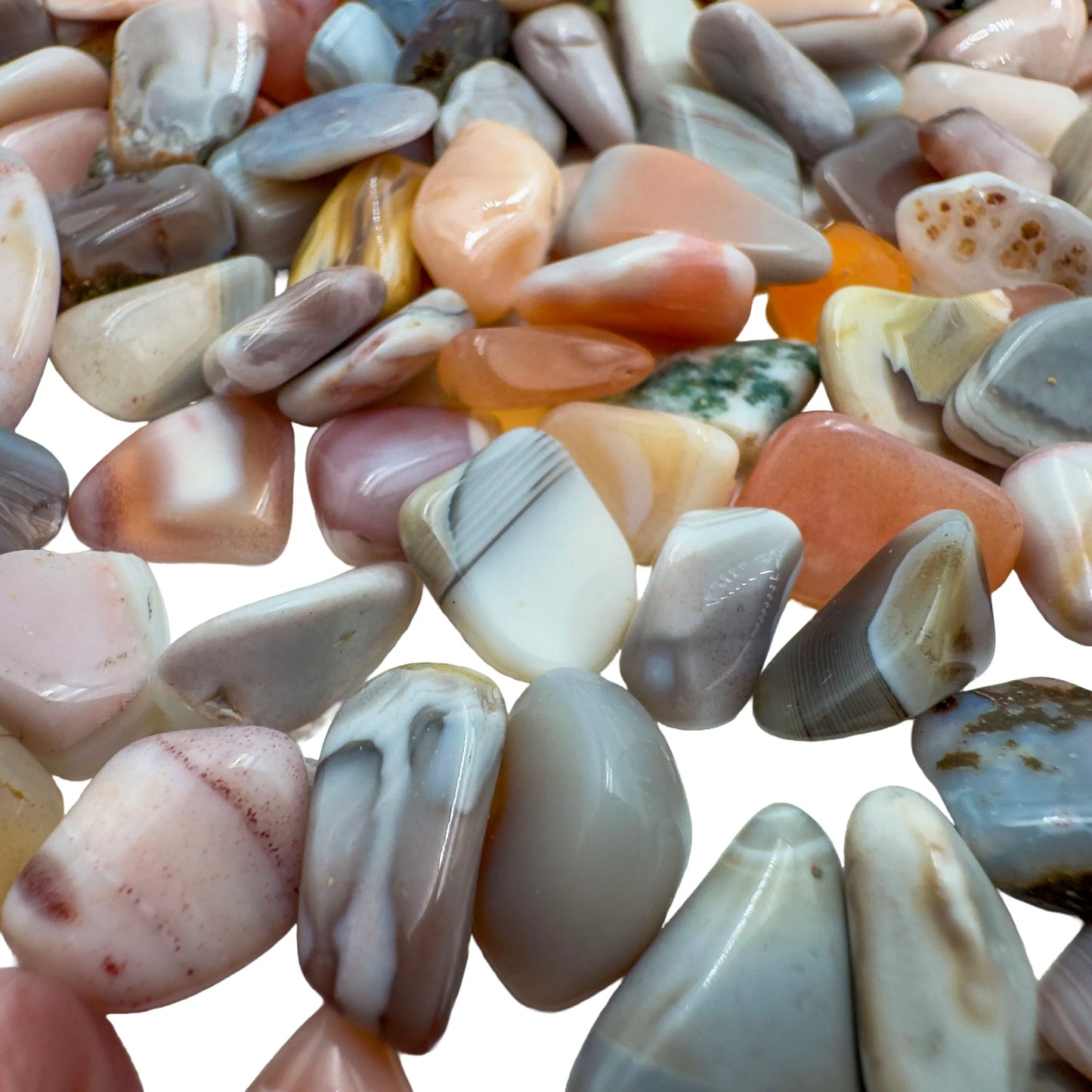 Pink agate polished chips in hand showing size reference, 0.25 to 0.50 inch pieces