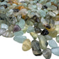 Prehnite polished chips in hand showing size reference, pale green Namibia material