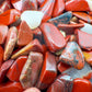 Aerial view of Red Jasper polished chip, often paired with practices around Grounding and Energy, sourced from South Africa.