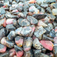 Edge view of Rhodonite polished chip, showing characteristic finish.