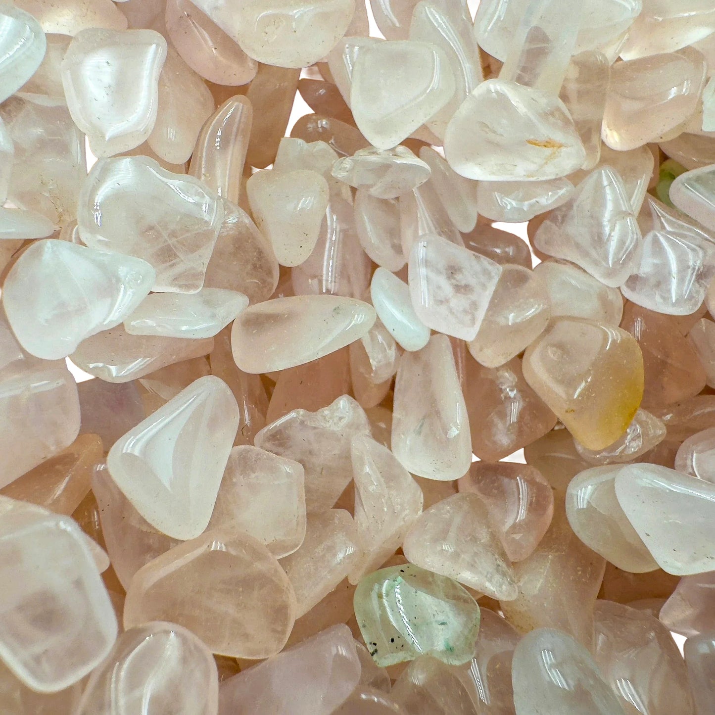 Top-down shot of Rose Quartz polished chip, showing soft luster.