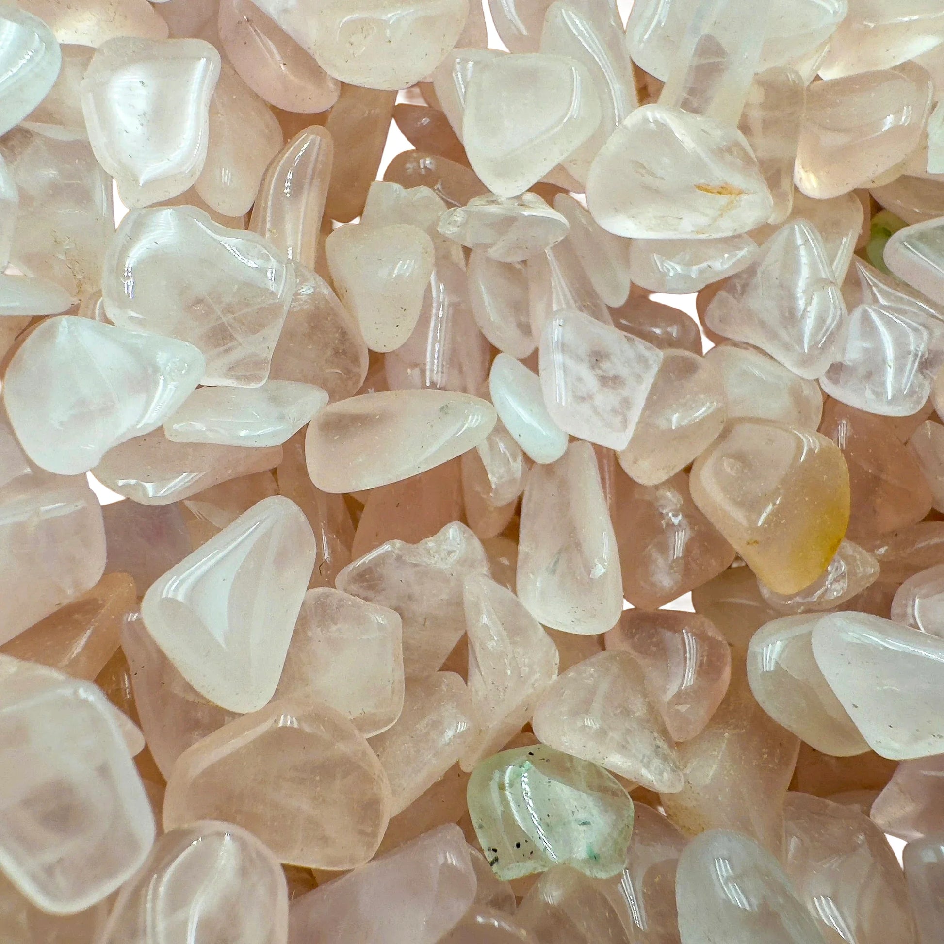 Top-down shot of Rose Quartz polished chip, showing soft luster.