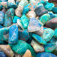 Edge-on view of Grade A Chrysocolla polished chip, showing earthy tone, sourced from Namibia.