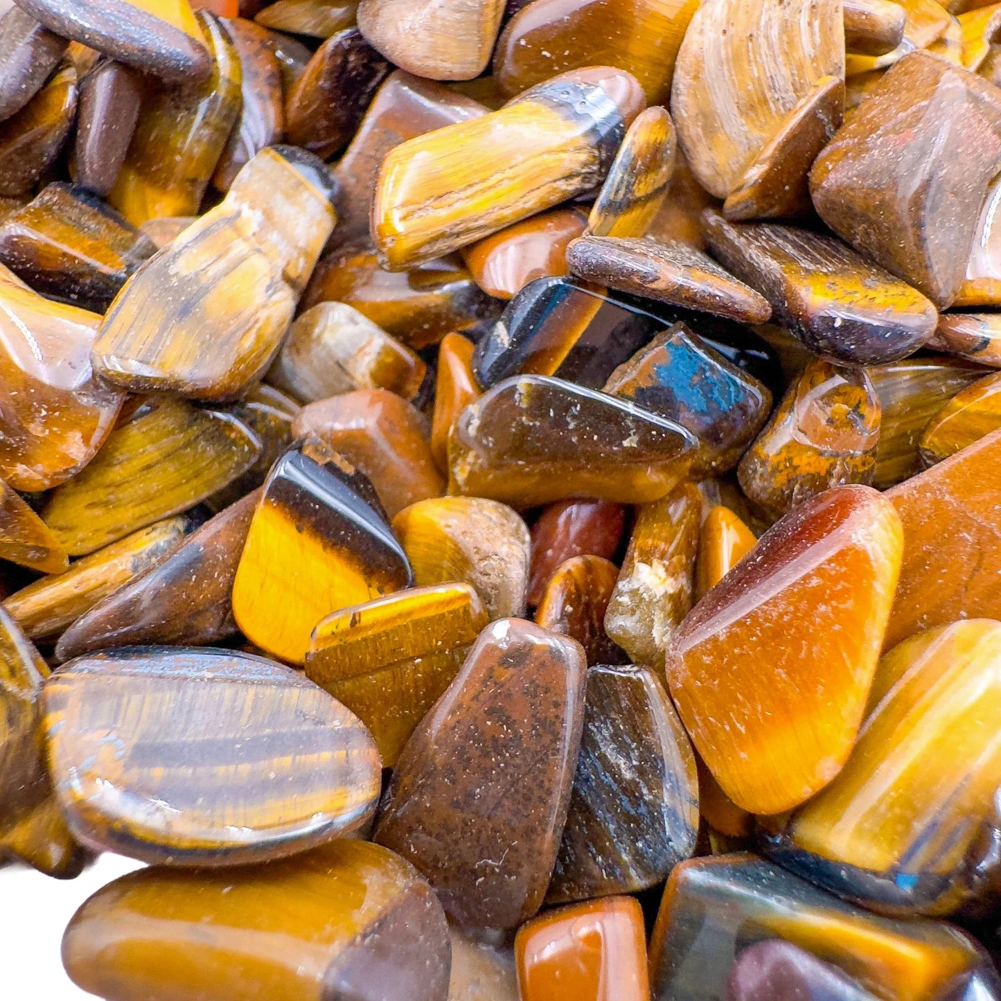 Close-up of Tiger Eye polished chip, turned to for Confidence and Career, showing natural sheen.