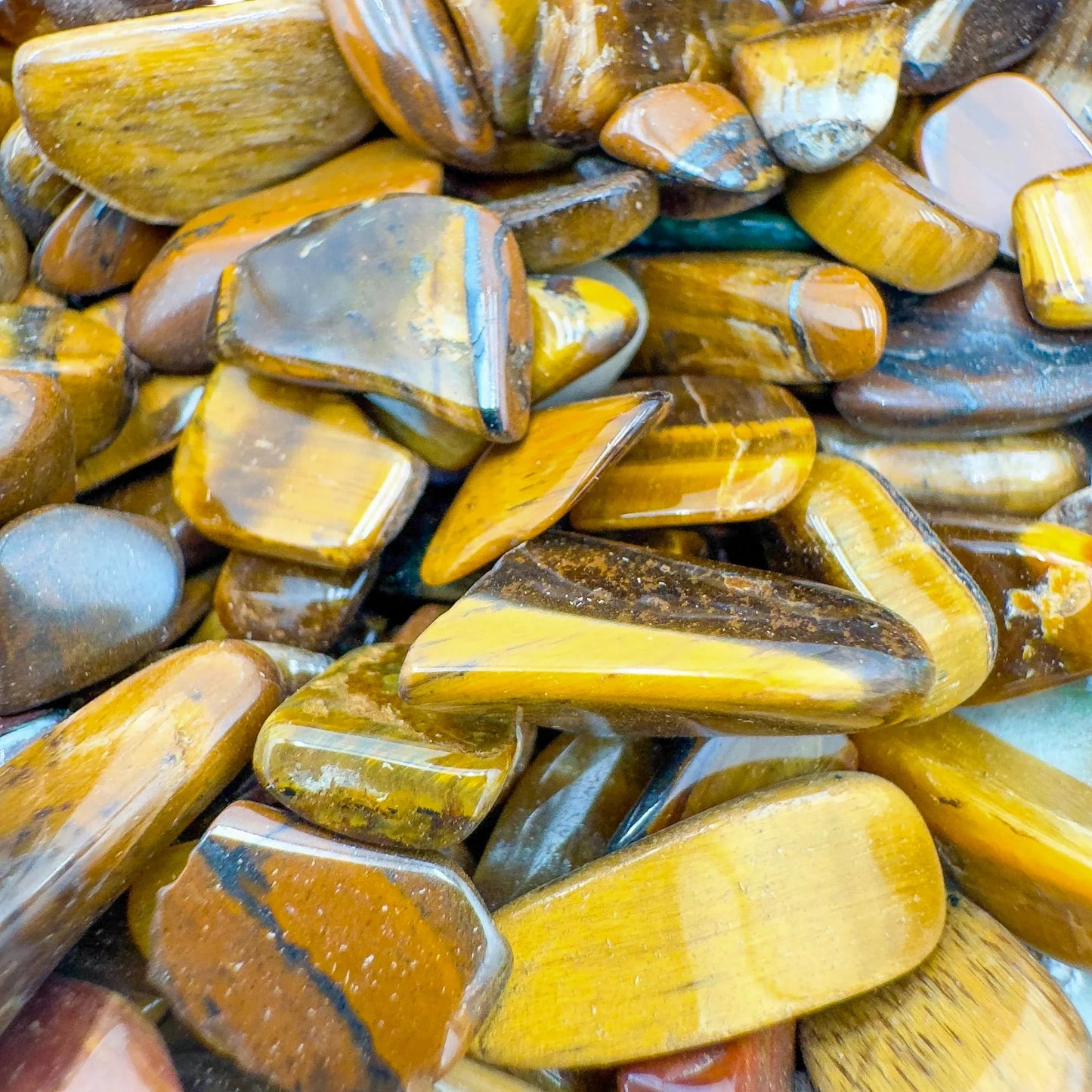 Lateral view of brown Tiger Eye polished chip, sourced from Northern Cape, South Africa.