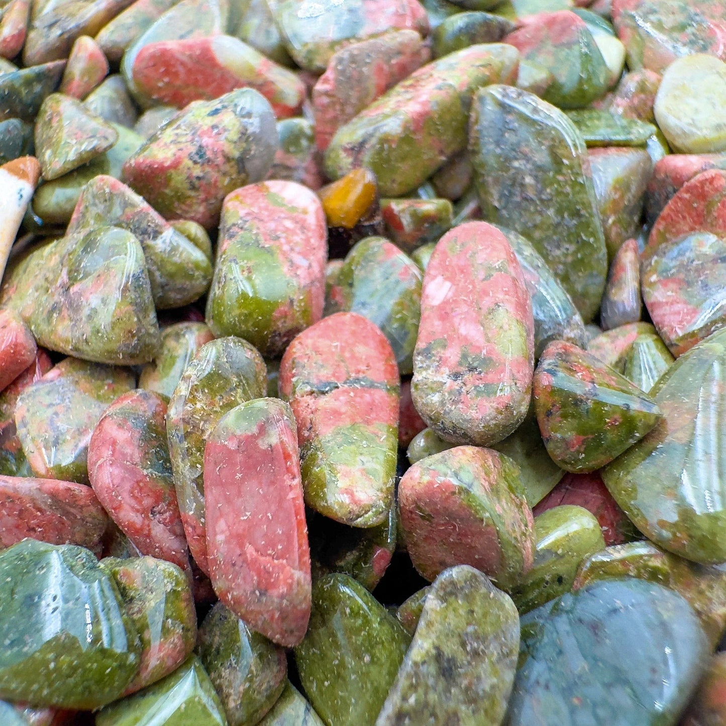 Macro view of Grade A green Unakite polished chip, sourced from Northern Cape, South Africa, showing characteristic finish.