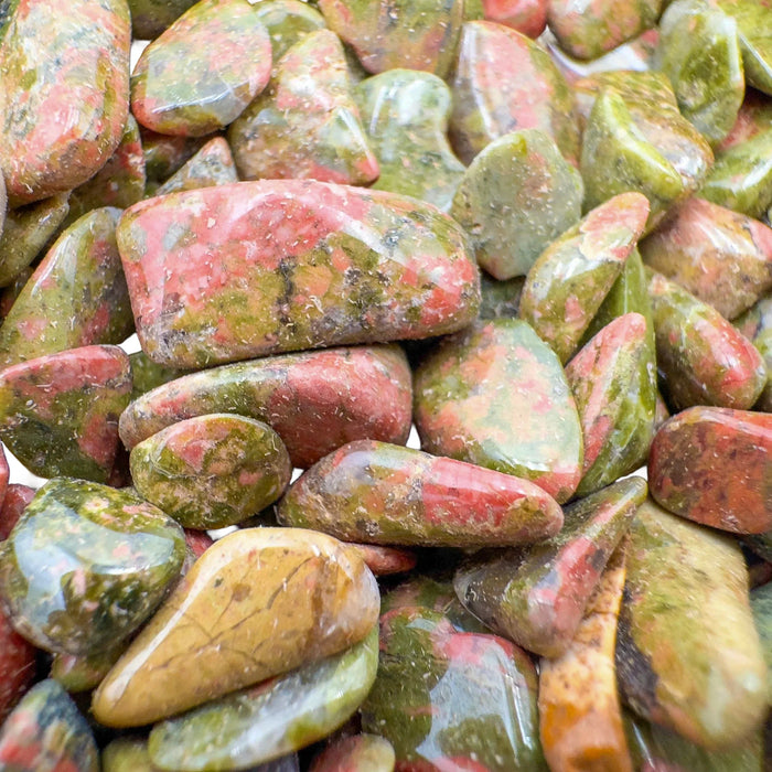 Side angle of Unakite polished chip, showing natural inclusions.