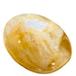 Side perspective of Golden Healer palm stone, showing natural sheen, kept close for Healing and Meditation.