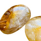 Overhead view of Golden Healer palm stone, turned to for Healing, showing earthy tone.