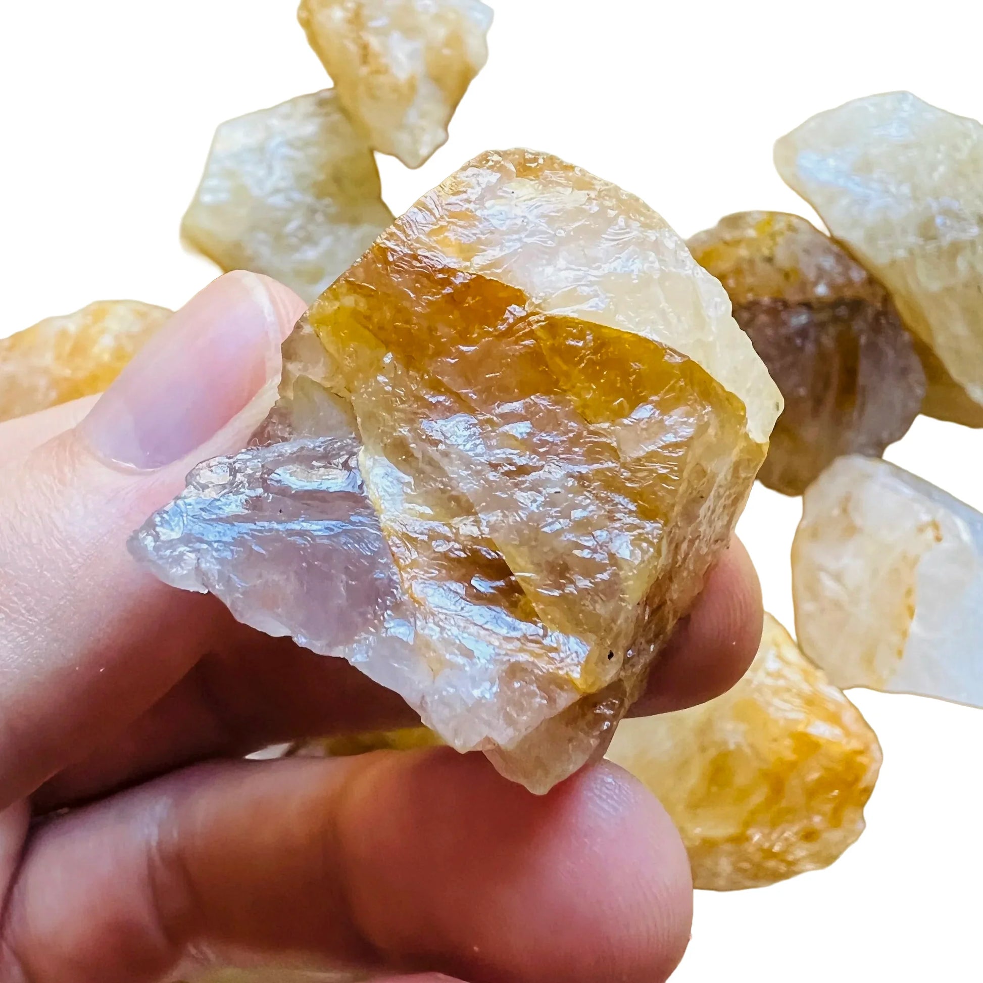 Display context of Golden Healer raw crystal, shown alongside the hand for scale.