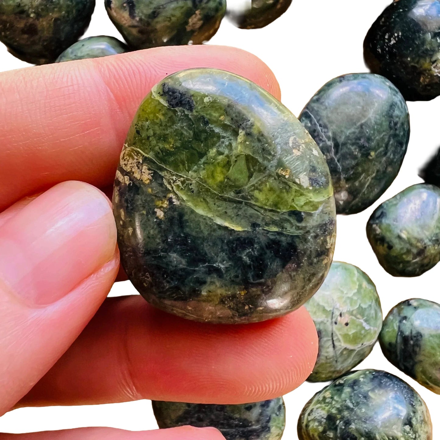 Lifestyle view of a Jade tumbled stone, sourced from Peru.