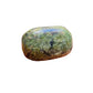 Natural light context of Jade tumbled stone, shown alongside the hand for scale.