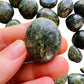 Back view of Grade A Jade tumbled stone showing natural surface