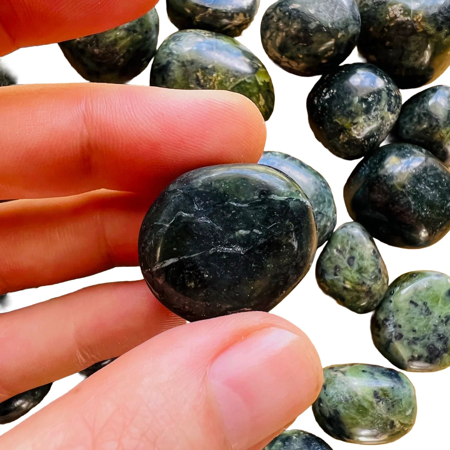 Detail shot of Grade A Jade tumbled stone under natural light