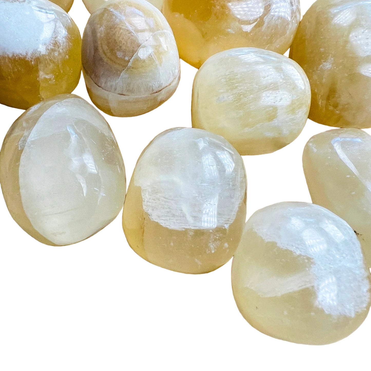 Side perspective of Honey Calcite tumbled stone, turned to for Confidence and Career, hand-selected from Ancash, Peru.