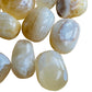 Bottom side of Honey Calcite tumbled stone, showing color depth.