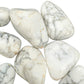 In-hand view of one Howlite tumbled stone for scale, Zimbabwe-sourced, from Masvingo, Zimbabwe.