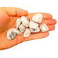 In-hand view of a Howlite tumbled stone, hand-selected from Masvingo, Zimbabwe.