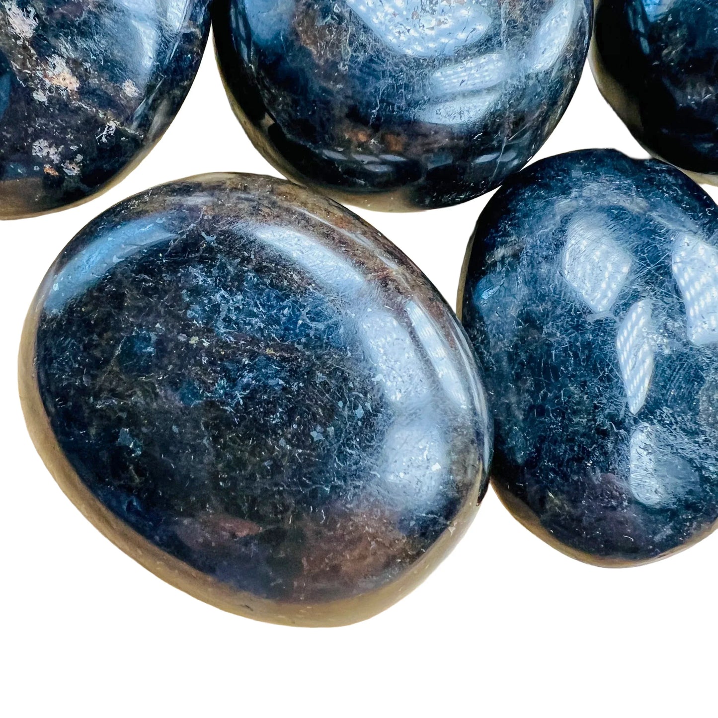Side perspective of Iolite palm stone, showing natural sheen, from Madagascar.