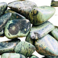 Plan view of Grade AA Kambaba Jasper tumbled stone, showing soft luster.
