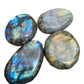 Detail shot of Grade AAA Labradorite palm stone under natural light