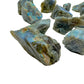 Side profile of Grade AA Labradorite raw stone, showing natural patina.