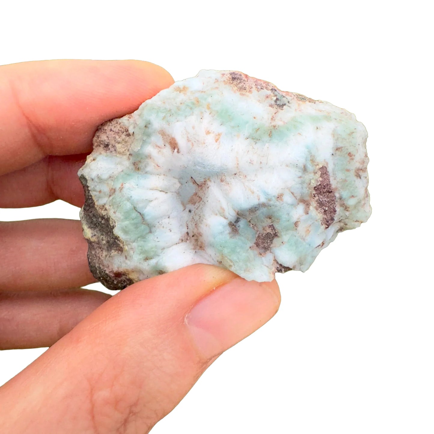 Top-down shot of blue Larimar raw stone, hand-selected from Barahona Province, Dominican Republic, worked with for Stress Relief.